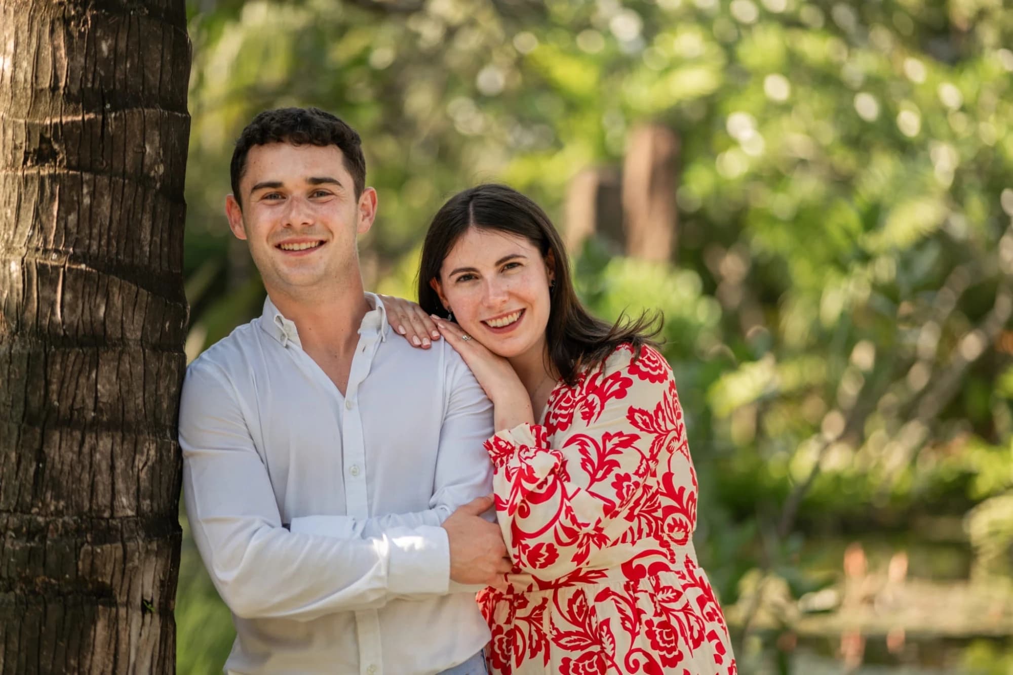 Bríd and Barry leaning against a palm tree